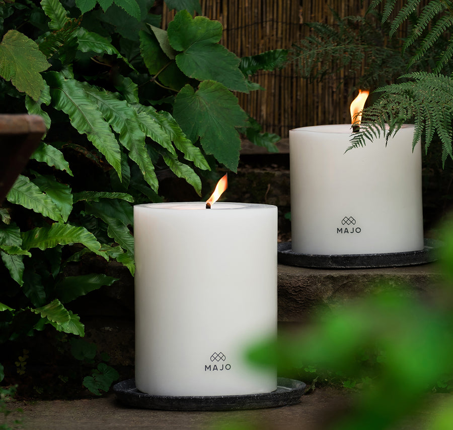 Large outdoor garden candles. Two MAJO candles alight outside. Candles with large flames that don't go out in the wind or rain.